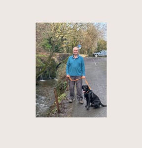 Stuart with his dog by the river in Lyme