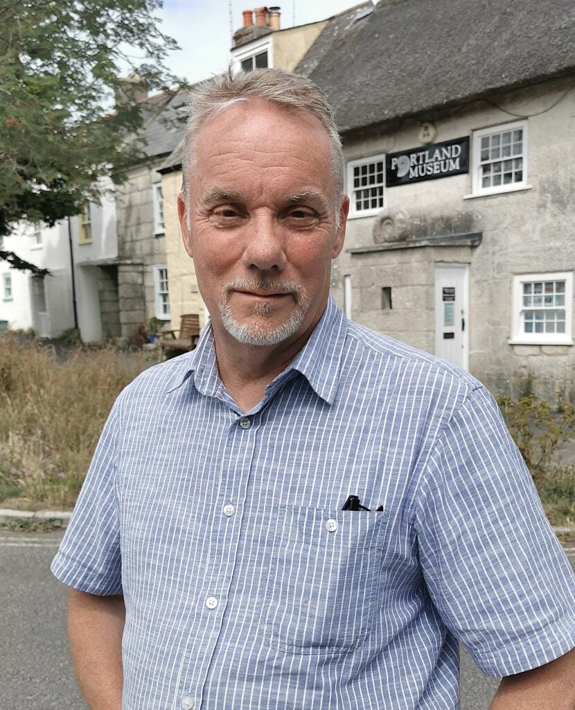 Mark WIlliams standing in front of Portland houses